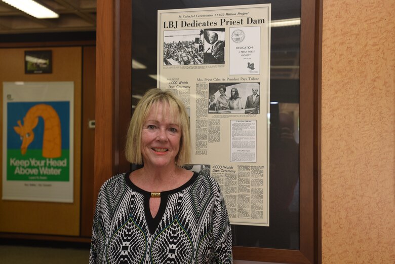 Harriett Priest, daughter of the late Congressman J. Percy Priest, poses by a historical news clipping at the J. Percy Priest Lake Visitor’s Center.  She visited following the 50th Anniversary of J. Percy Priest Dam and Reservoir at the dam in Nashville, Tenn., June 29, 2018. (USACE Photo by Lee Roberts)