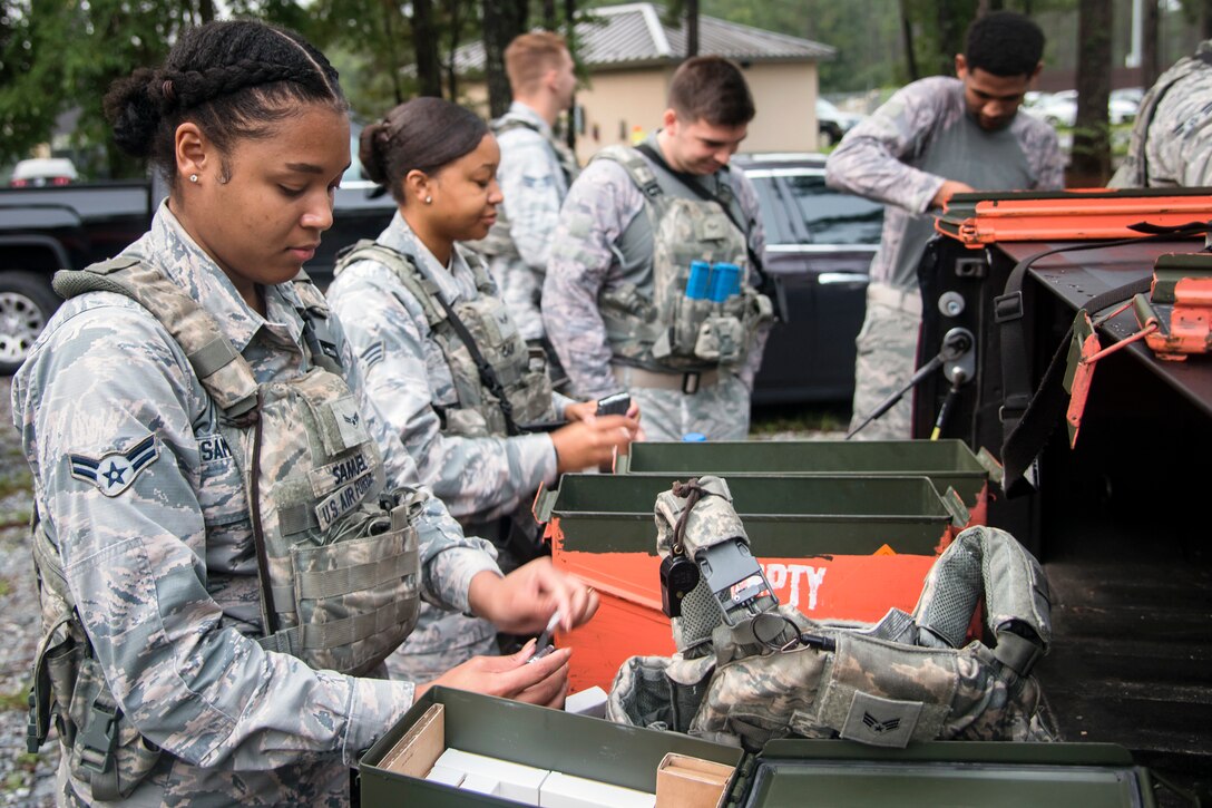 Airmen from the 23d Security Forces Squadron (SFS) load simulated bullets into magazines prior to a Force on Force training scenario, June 29, 2018, at Moody Air Force Base, Ga. This training was held to ensure SFS Airmen are proficient in various tactics and procedures such as: building clear out, team movements, hostage rescue and properly applying cover fire. The scenario required Airmen to maneuver through multiple buildings to rescue a simulated victim guarded by opposing forces. (U.S. Air Force photo Airman 1st Class Eugene Oliver)
