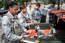 Airmen from the 23d Security Forces Squadron (SFS) load simulated bullets into magazines prior to a Force on Force training scenario, June 29, 2018, at Moody Air Force Base, Ga. This training was held to ensure SFS Airmen are proficient in various tactics and procedures such as: building clear out, team movements, hostage rescue and properly applying cover fire. The scenario required Airmen to maneuver through multiple buildings to rescue a simulated victim guarded by opposing forces. (U.S. Air Force photo Airman 1st Class Eugene Oliver)