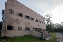 An Airman from the 23d Security Forces Squadron (SFS) applies cover fire with an M4 Carbine into a building during a Force on Force training scenario, June 29, 2018, at Moody Air Force Base, Ga. This training was held to ensure SFS Airmen are proficient in various tactics and procedures such as: building clear out, team movements, hostage rescue and properly applying cover fire. The scenario required Airmen to maneuver through multiple buildings to rescue a simulated victim guarded by opposing forces. (U.S. Air Force photo Airman 1st Class Eugene Oliver)