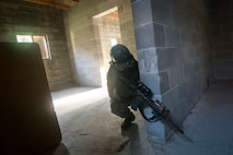 An Airman from the 23d Security Forces Squadron (SFS) scans his perimeter during a Force on Force training scenario, June 29, 2018, at Moody Air Force Base, Ga. This training was held to ensure SFS Airmen are proficient in various tactics and procedures such as: building clear out, team movements, hostage rescue and properly applying cover fire. The scenario required Airmen to maneuver through multiple buildings to rescue a simulated victim guarded by opposing forces. (U.S. Air Force photo Airman 1st Class Eugene Oliver)
