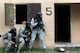 Airmen from the 23d Security Forces Squadron (SFS) prepare to clear a building during a Force on Force training scenario, June 29, 2018, at Moody Air Force Base, Ga. This training was held to ensure SFS Airmen are proficient in various tactics and procedures such as: building clear out, team movements, hostage rescue and properly applying cover fire. The scenario required Airmen to maneuver through multiple buildings to rescue a simulated victim guarded by opposing forces. (U.S. Air Force photo Airman 1st Class Eugene Oliver)