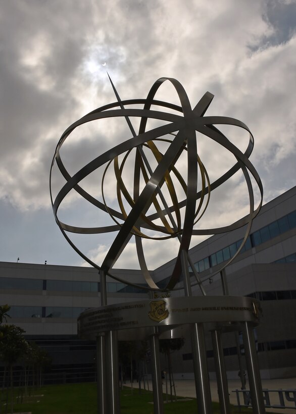 Armillary Sphere, adopted symbol of Space and Missile Systems Center at Los Angeles Air Force Base, points to partial solar eclipse at approximately 61 percent obscuration of sun at 10:20 a.m. local time, El Segundo, California, August 21, 2017 (U.S. Air Force/Sarah Corrice)