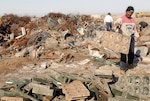 An Iraqi national separates scrap metal to be salvaged and recycled into cash while at Forward Operating Base Warhorse, located in Diyala, Iraq.