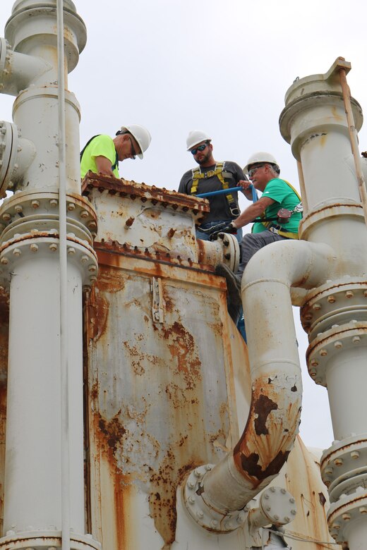 Carpenter Shop team members complete measurements at the von Kármán Gas Dynamics Facility for the construction of a platform. Pictured from left are Don Parker, Brad Summers and Allen Mull. (U.S. Air Force photo/Bradley Hicks) (This image was manipulated by obscuring badges for security purposes)