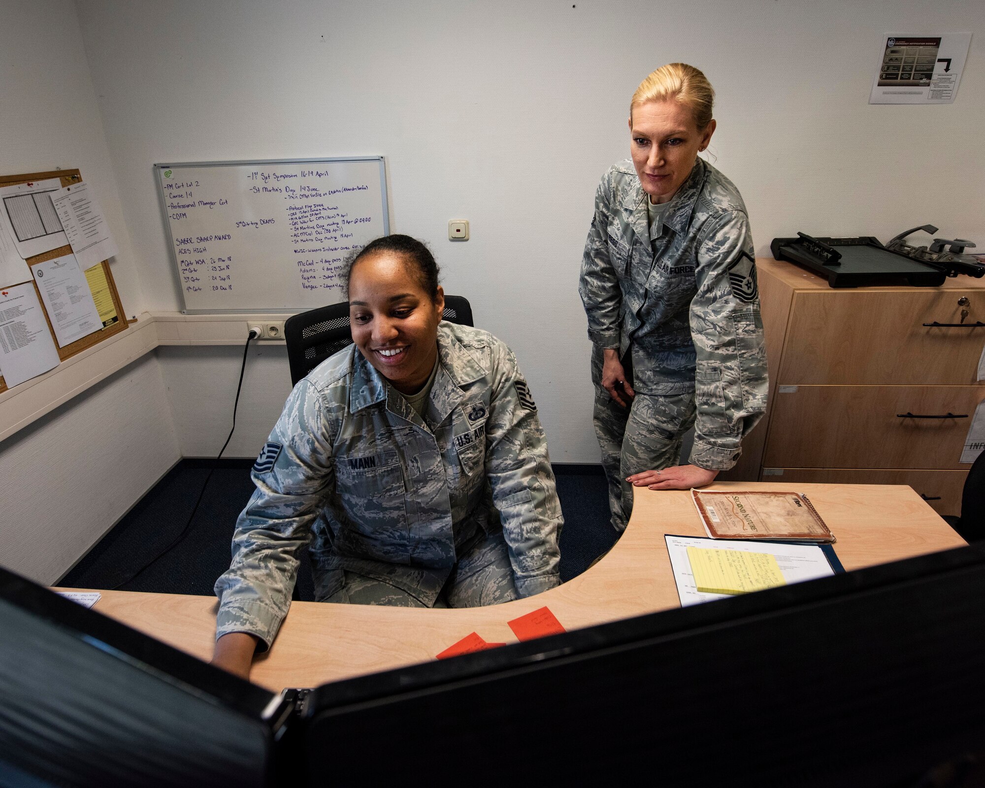 Master Sgt. Brandy Trego, budget analyst with the 141st Air Refueling Wing’s comptroller flight, assists Tech. Sgt. Tameka Mann, 52nd munitions maintenance group resource advisor, during training April 17, 2018 at Spangdahlem Air Base, Germany. Trego was one of nearly 20 Guardsmen that had the opportunity to complete their annual training alongside their active duty counterparts in early April at Spangdahlem.