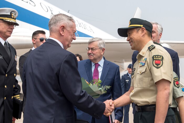 Defense Secretary James N. Mattis shakes hands with a foreign service member.