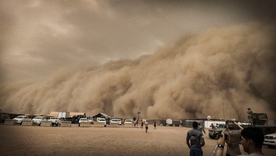 U.S. service members observe and take photos of a sand storm at Nigerien Air Base 201, Niger, June 24, 2018. This was the largest sand storm of the season so far, with sustained winds in excess of 50 knots. (U.S. Air Force courtesy photo by Master Sgt. William S. McDuffie)