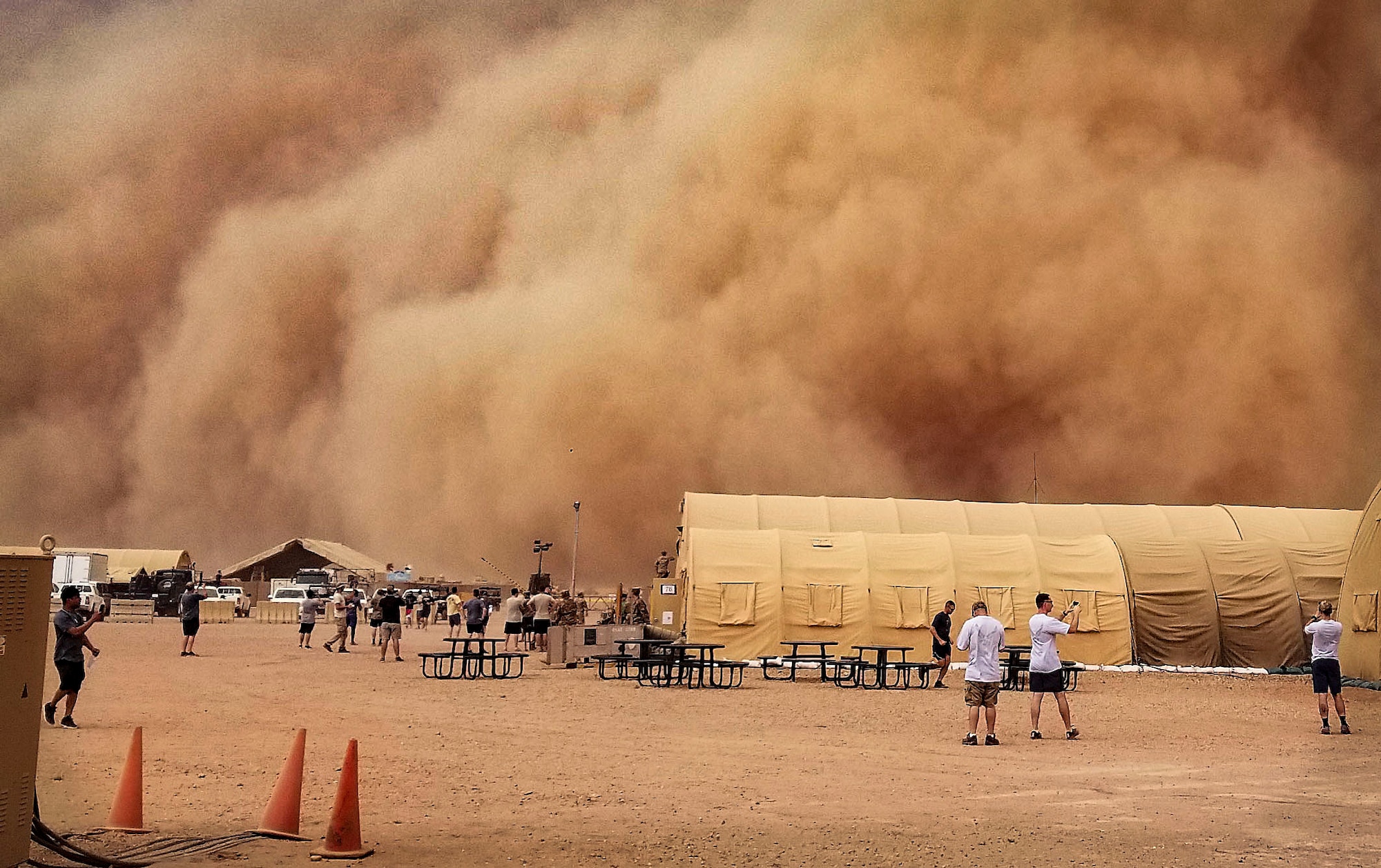 U.S. service members observe and take photos of a sand storm at Nigerien Air Base 201, Niger, June 24, 2018. Sand storms are a normal occurrence during the summer seasons in Northwest Africa. (U.S. Air Force courtesy photo by Airman 1st Class Anthony Montero)