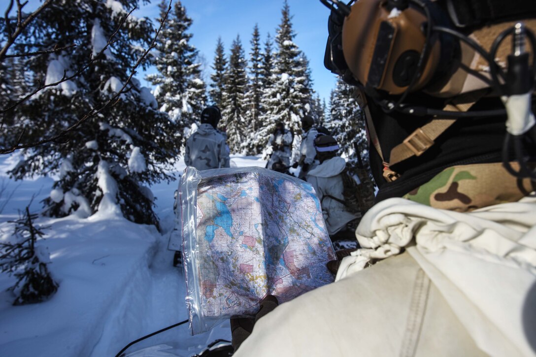 U.S. Army 10th Special Forces Group (Airborne) Soldier checks map of training area during long-range snowmobile movement drill for Northern Griffin 2018 in Rovaniemi, Finland, March 12, 2018 (U.S. Army/Kent Redmond)