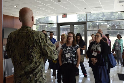 Chief Petty Officer Greg Wistain, a Sailor assigned to the Navy Medicine Training Support Center at Joint Base San Antonio-Fort Sam Houston, speaks to a tour group of San Antonio middle and high school guidance counselors June 27. The tour provided educators and counselors with a general overview of the Navy, to raise awareness of Navy career opportunities through a tour of the medical training campus.