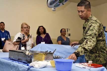 Lt. Cmdr. Kirby Jahnke, Navy Medicine Training Support Center, shows medical instruments to a tour group of San Antonio middle and high school guidance counselors June 27. The tour provided educators and counselors with a general overview of the Navy, to raise awareness of Navy career opportunities through a tour of the medical training campus.