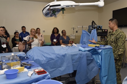 Lt. Cmdr. Kirby Jahnke, Navy Medicine Training Support Center, speaks to a tour group of San Antonio middle and high school guidance counselors June 27. The tour provided educators and counselors with a general overview of the Navy, to raise awareness of Navy career opportunities through a tour of the medical training campus.