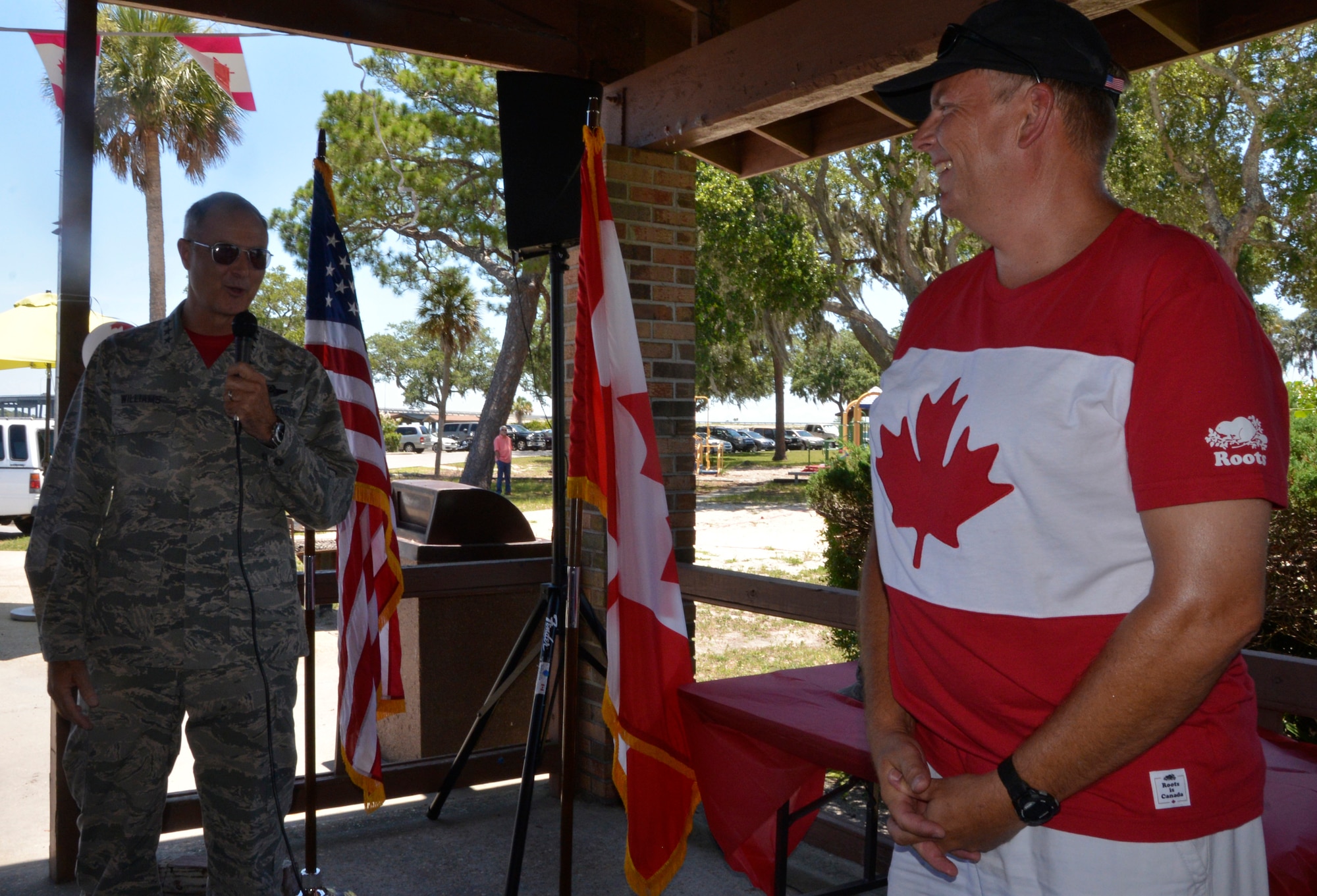 Lt. Gen. R. Scott Williams, Commander, 1st Air Force (Air Forces Northern) – Continental U.S. Region, makes opening remarks much enjoyed by Royal Canadian Air Force LCol Brian Murray, the CONR Canadian Detachment commander, during locally-observed Canada Day festivities at Bonita BayJune 29. Officially celebrated July 1, Canada Day celebrates the Constitution Act, which in 1867, brought together the colonies of the Province of Canada, Nova Scotia and New Brunswick into what is now known as Canada. (U.S. Air Force Photo by Mary McHale)