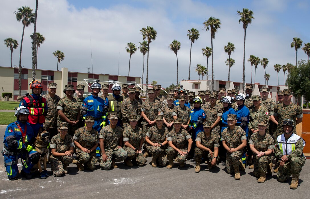 U.S. Marines, with 15th Marine Expeditionary Unit, and Mexican sailors, with Corvette Licensed Naval Health Service, pose for a group photo after a humanitarian assistance and disaster relief demonstration as part of Rim of the Pacific (RIMPAC) exercise at Marine Corps Base Camp Pendleton, California, June 29, 2018. Marines training with partner nations from around the world enhances prowess. RIMPAC provides high-value training for task-organized, highly-capable Marine Air-Ground Task Force and enhances the critical crisis response capability of U.S. Marines in the Pacific.