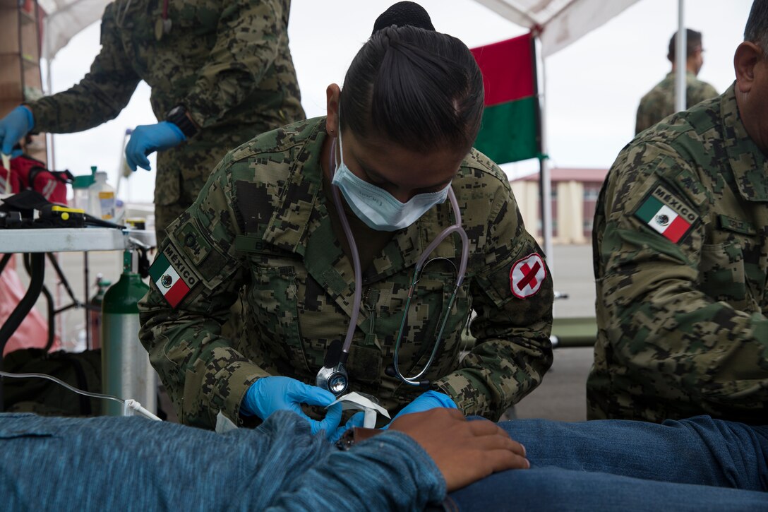Mexican Navy Lt. Ruth B. Bolanos, a combat nurse with Corvette Licensed Naval Health Service, treats a simulated casualty during a humanitarian assistance and disaster relief demonstration as part of Rim of the Pacific (RIMPAC) exercise at Marine Corps Base Camp Pendleton, California, June 29, 2018. Marines training with partner nations from around the world enhances prowess. RIMPAC provides high-value training for task-organized, highly-capable Marine Air-Ground Task Force and enhances the critical crisis response capability of U.S. Marines in the Pacific.