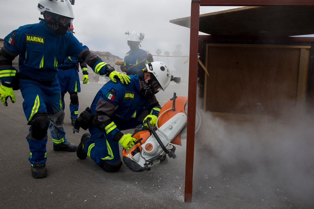 Mexican sailors, with Corvette Licensed Naval Health Service, cut through a wall during a humanitarian assistance and disaster relief demonstration as part of Rim of the Pacific (RIMPAC) exercise at Marine Corps Base Camp Pendleton, California, June 29, 2018. Marines training with partner nations from around the world enhances prowess. RIMPAC provides high-value training for task-organized, highly-capable Marine Air-Ground Task Force and enhances the critical crisis response capability of U.S. Marines in the Pacific.