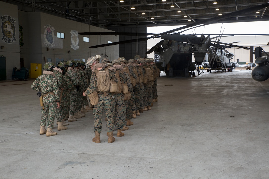 Malaysian service members and U.S. Marines prepare to board a CH-53E Super Stallion helicopter during ground-air integration training (GAIT) as part of Rim of the Pacific (RIMPAC) exercise at Marine Corps Air Station Kaneohe Bay, Hawaii, June 27, 2018. GAIT provides the service members with familiarity with boarding and exiting an aircraft. RIMPAC provides high-value training for task-organized, highly-capable Marine Air-Ground Task Force and enhances the critical crisis response capability of U.S. Marines in the Pacific. Twenty-five nations, 46 ships, five submarines, about 200 aircraft and 25,000 personnel are participating in RIMPAC from June 27 to Aug. 2 in and around the Hawaiian Islands and Southern California.