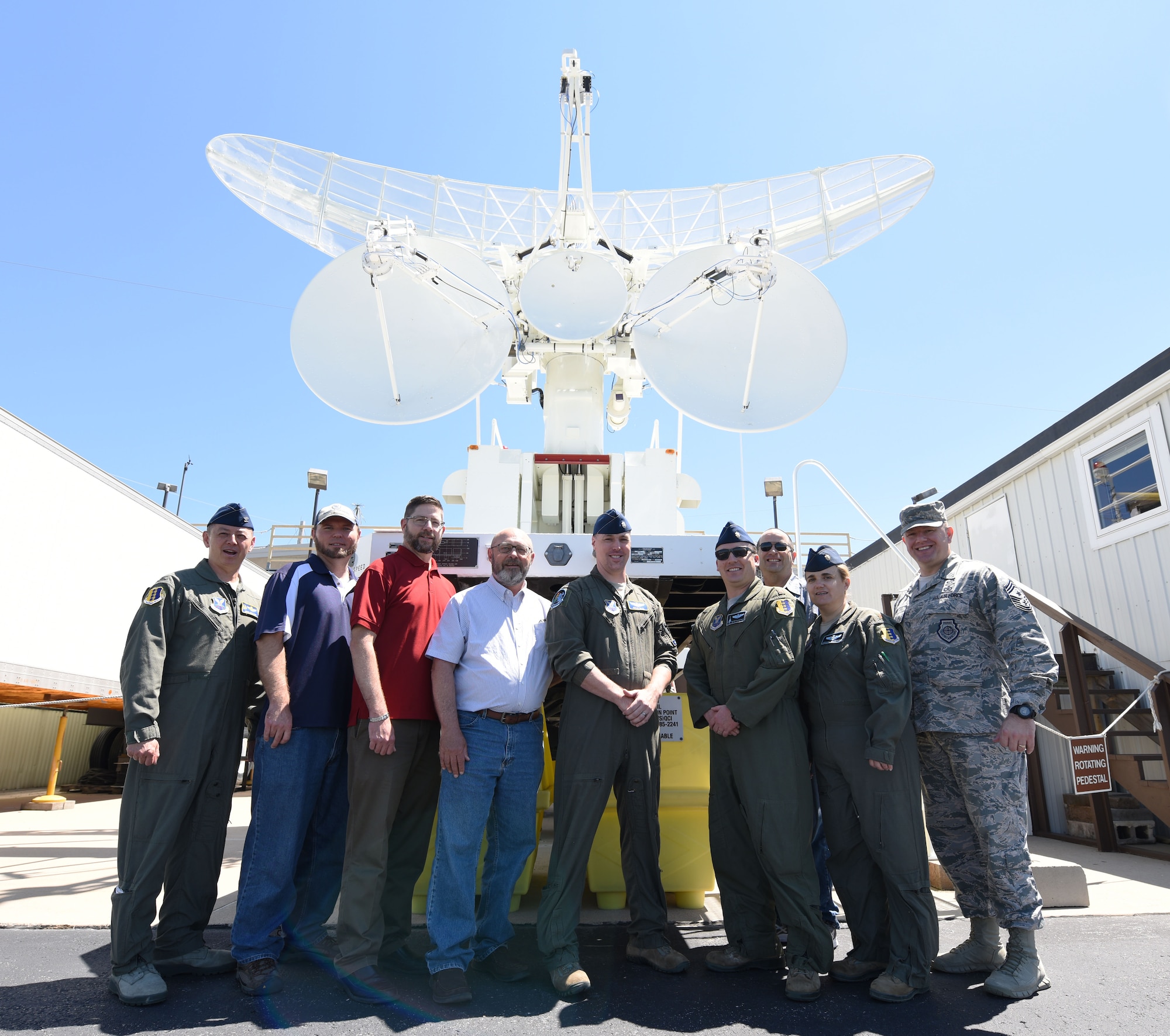 28th Bomb Wing leadership and radar technicians stand in front of a multiple-input single-output radar at the Powder River Training Complex in Colony, Wyoming, June 21, 2018.  Ellsworth leadership has been working with the community to help overcome obstacles and form a stronger partnership that would be mutually beneficial to both parties. (U.S. Air Force phot by Airman 1st Class Thomas Karol)