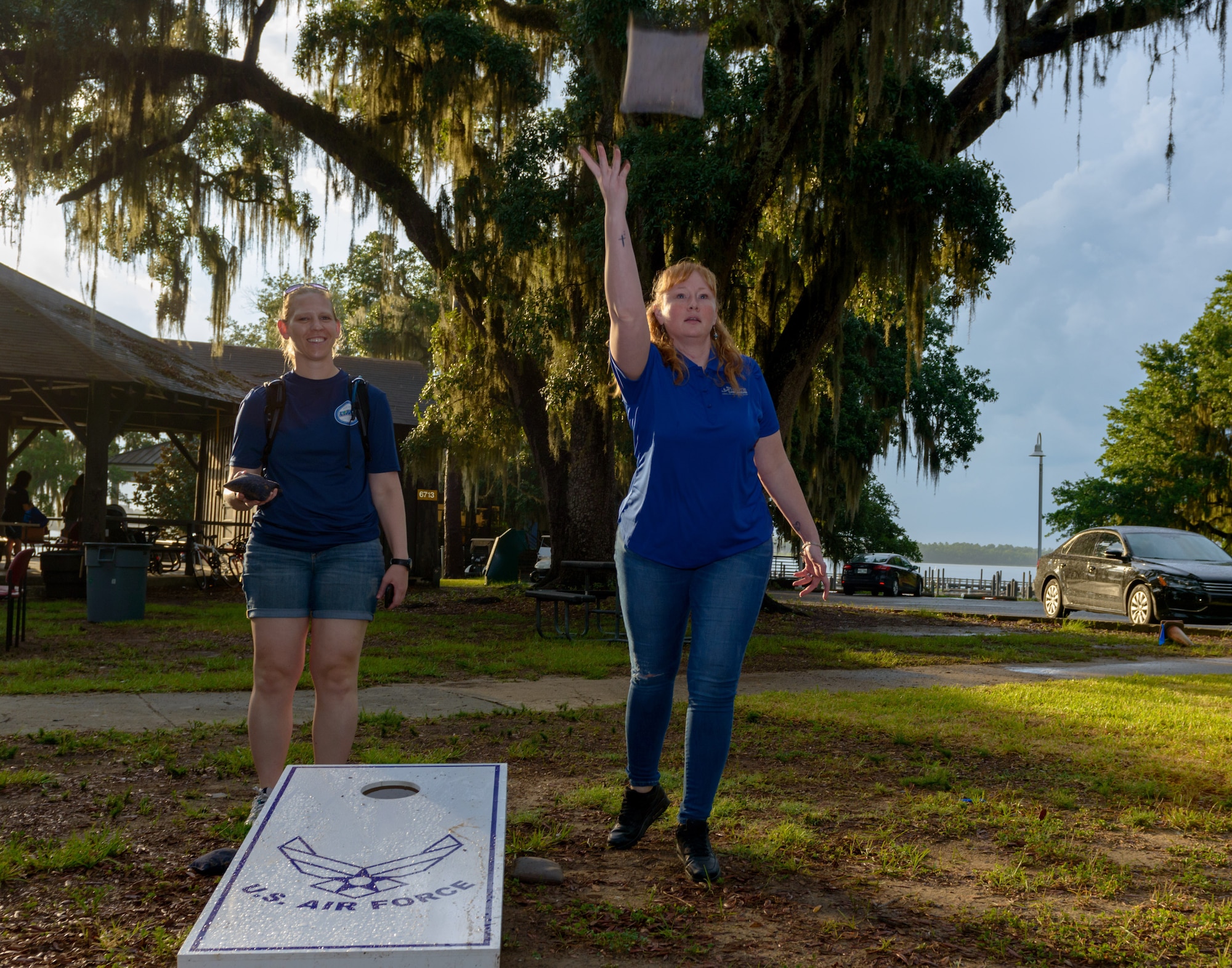 U.S. Air Force Maj. Erin Holland, 81st Force Support Squadron operations officer, and Master Sgt. Krista Mercadel, 81st FSS force management superintendent, play corn hole during Freedom Fest at Marina Park on Keesler Air Force Base, Mississippi, June 30, 2018. The event included carnival rides, a burger cook-off, hot wings and watermelon eating competitions and a fireworks display. (U.S. Air Force photo by Andre’ Askew)