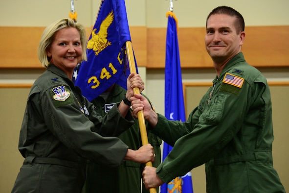 Col. Christopher Menuey, right, accepts command of the 341st Operations Group from Col. Jennifer Reeves, 341st Missile Wing commander, during an assumption of command ceremony July 3, 2018, at Malmstrom AFB, Mont.