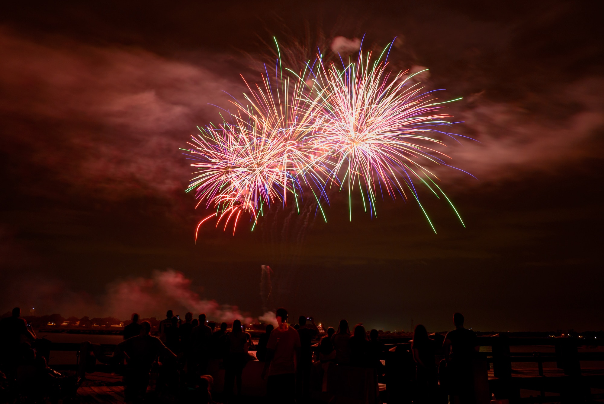 Keesler families watch a firework display during Freedom Fest at Marina Park on Keesler Air Force Base, Mississippi, June 30, 2018. The event included carnival rides, a burger cook-off and hot wings and watermelon eating competitions. (U.S. Air Force photo by Andre’ Askew)