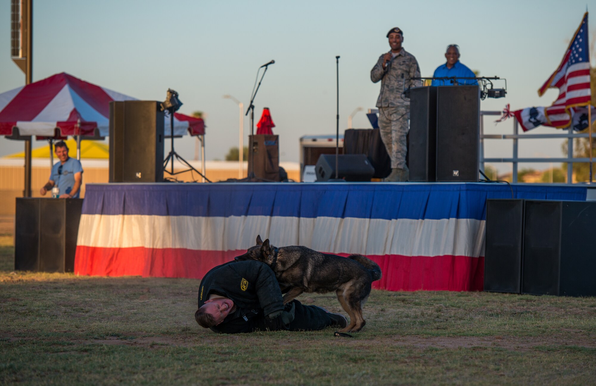 An Airman assigned to the 56th Security Forces Squadron participates in a military working dog demonstration during the annual Freedom Fest celebration June 29, 2018 at Luke Air Force Base, Ariz. The festival kicked off with a MWD demo to showcase the MWD’s capabilities of biting and holding potential suspects. (U.S. Air Force photo by Airman 1st Class Alexander Cook)