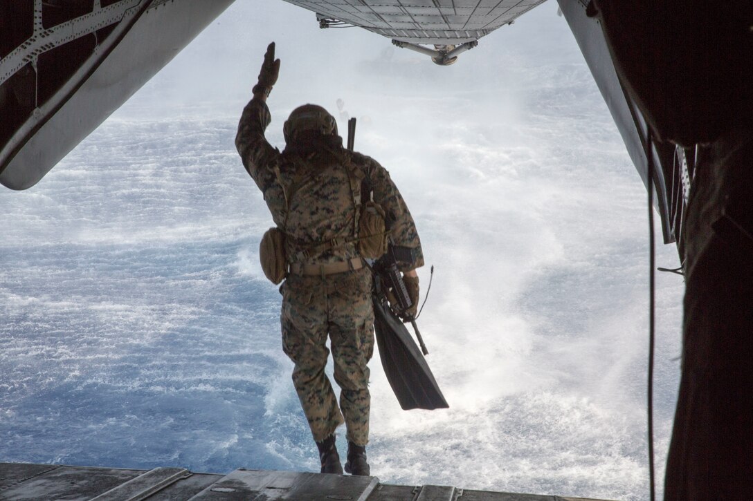 A U.S. Marine with the 3rd Reconnaissance Battalion jumps from a CH-53E Super Stallion helicopter during amphibious operations as part of Rim of the Pacific (RIMPAC) exercise on Marine Corps Base Hawaii July 2, 2018. RIMPAC provides high-value training for task-organized, highly-capable Marine Air-Ground Task Force and enhances the critical crisis response capability of U.S. Marines in the Pacific. Twenty-five nations, 46 ships, five submarines, about 200 aircraft and 25,000 personnel are participating in RIMPAC from June 27 to Aug. 2 in and around the Hawaiian Islands and Southern California. (U.S. Marine Corps photo by Lance Cpl. Thomas P. Miller)
