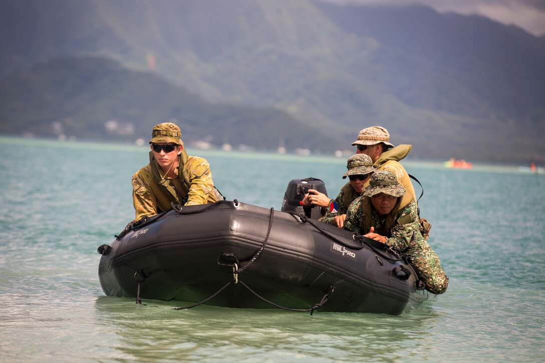 Australian soldiers and Philippine Marines team together on a Zodiac Mark 2 Grand Raider general purpose inflatable boat during a beach insertion rehearsal as part of Rim of the Pacific (RIMPAC) exercise at Marine Corps Base Hawaii July 1, 2018. RIMPAC provides high-value training for task-organized, highly-capable Marine Air-Ground Task Force and enhances the critical crisis response capability of U.S. Marines in the Pacific. Twenty-five nations, 46 ships, five submarines, about 200 aircraft and 25,000 personnel are participating in RIMPAC from June 27 to Aug. 2 in and around the Hawaiian Islands and Southern California. (U.S. Marine Corps photo by Sgt. Zachary Orr)