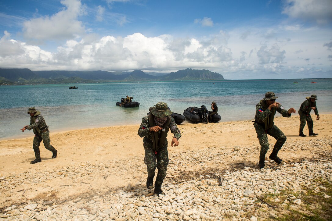 Philippine Marines simulate a beach raid during a beach insertion rehearsal as part of Rim of the Pacific (RIMPAC) exercise on Marine Corps Base Hawaii July 1, 2018. RIMPAC provides high-value training for task-organized, highly-capable Marine Air-Ground Task Force and enhances the critical crisis response capability of U.S. Marines in the Pacific. Twenty-five nations, 46 ships, five submarines, about 200 aircraft and 25,000 personnel are participating in RIMPAC from June 27 to Aug. 2 in and around the Hawaiian Islands and Southern California.(U.S. Marine Corps photo by Sgt. Zachary Orr)
