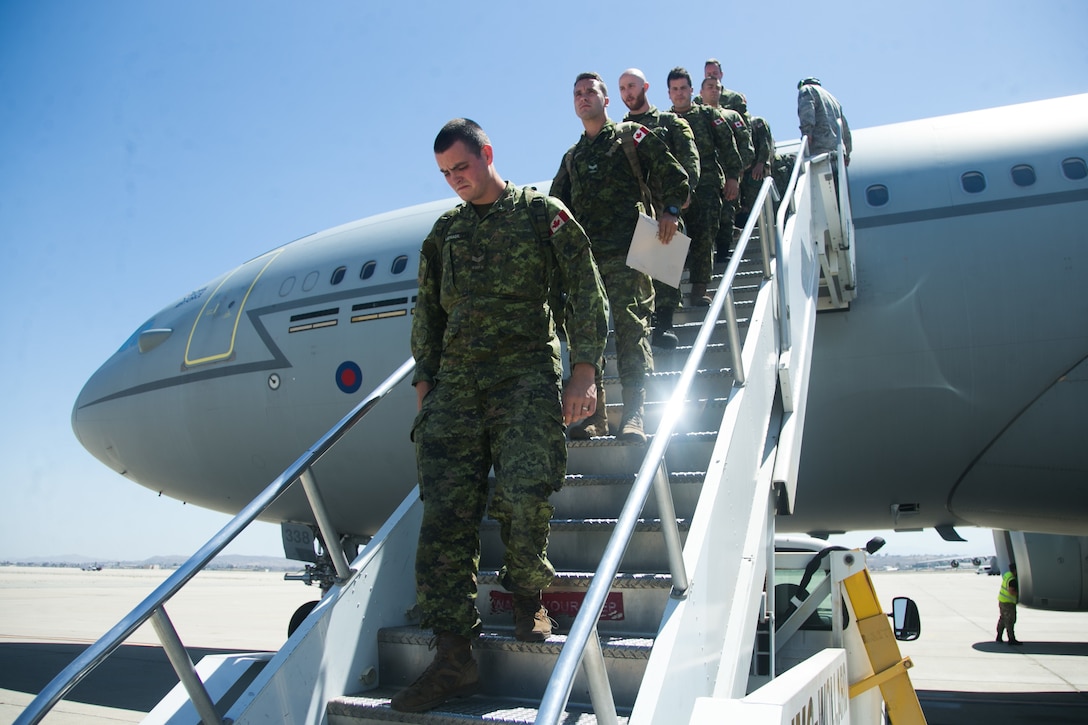 Canadian soldiers with the 2e Battalion, Royal 22e Régiment, Canadian Armed Forces, exit a Royal Air Force Airbus (KC2 Voyager) to participate in the Rim of the Pacific (RIMPAC) exercise at March Air Reserve Base, California, June 25, 2018. Twenty-five nations, more than 45 ships and submarines, about 200 aircraft and 25,000 personnel are participating in RIMPAC from June 27 to Aug. 2 in and around the Hawaiian Islands and Southern California. Marines training with the U.S. Navy and partner nations from around the world enhances prowess. RIMPAC provides high-value training for task-organized, highly-capable Marine Air-Ground Task Force and enhances the critical crisis response capability of U.S. Marines in the Pacific.