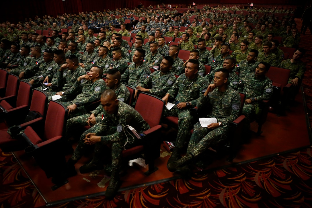 U.S. and foreign service members attend a safety brief in relation to the Rim of the Pacific (RIMPAC) exercise at the base theater aboard Marine Corps Base Hawaii (MCBH) June 27, 2018. The brief informed exercise participants on the rules, regulations, and requirements for all ranges and training areas aboard MCBH. The brief also provided awareness of the cultural and natural resources related to MCBH. Twenty-five nations, more than 45 ships and submarines, about 200 aircraft, and 25,000 personnel are participating in RIMPAC from June 27 to Aug. 2 in and around the Hawaiian Islands and Southern California. The world's largest international maritime exercise, RIMPAC provides a unique training opportunity while fostering and sustaining cooperative relationships among participants critical to ensuring the safety of sea lanes and security on the world's oceans.