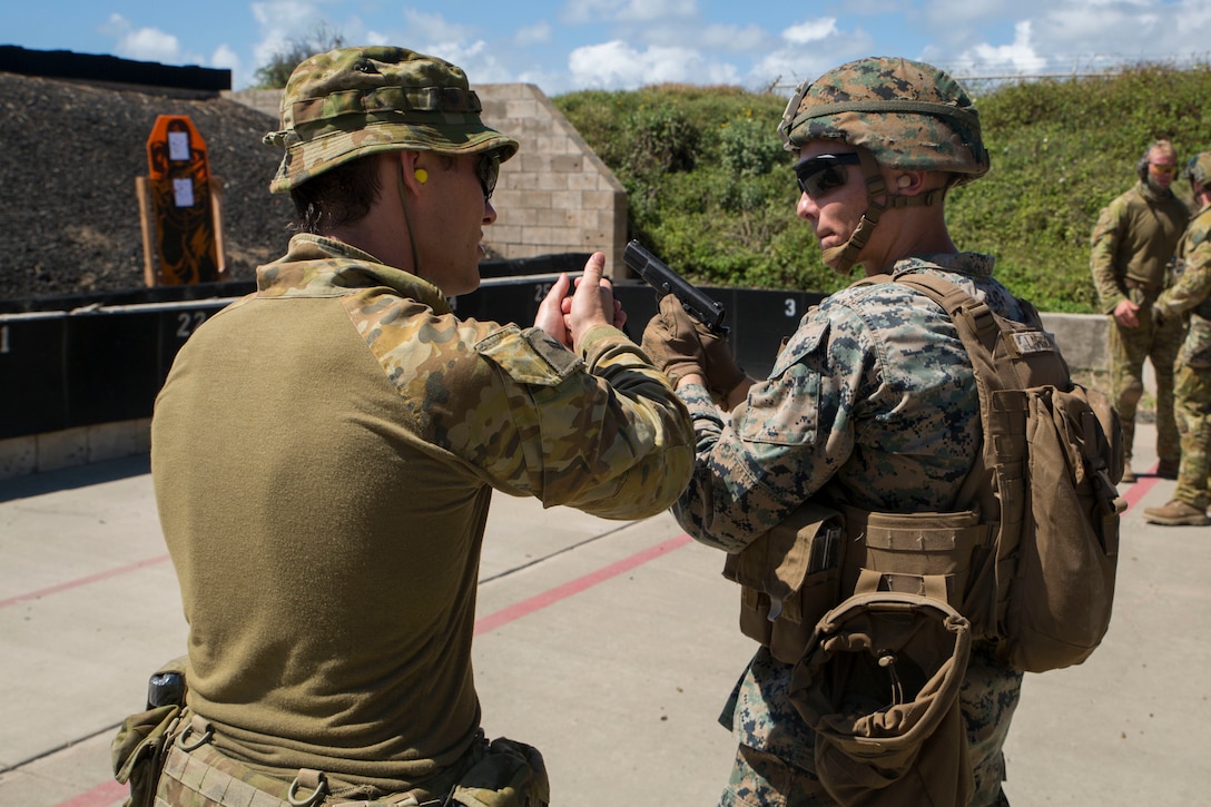 Australian Army Cpl. Peter Swan, an infantryman with the 2nd Battalion, Royal Australian Regiment, provides weapons handling instructions to a U.S. Marine during a live fire training event as part of Rim of the Pacific (RIMPAC) exercise at the Ulupa’u Crater Range Training Facility on Marine Corps Base Hawaii June 29, 2018. RIMPAC provides high-value training for task-organized, highly-capable Marine Air-Ground Task Force and enhances the critical crisis response capability of U.S. Marines in the Pacific. Twenty-five nations, 46 ships, five submarines, about 200 aircraft and 25,000 personnel are participating in RIMPAC from June 27 to Aug. 2 in and around the Hawaiian Islands and Southern California.