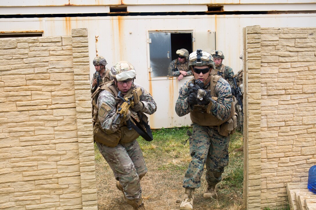 A Chilean and U.S. Marine practice clearing a room together during urban operations training as part of Rim of the Pacific (RIMPAC) exercise aboard Marine Corps Base Hawaii June 28, 2018. Marines training with the U.S. Navy and partner nations from around the world enhances prowess. RIMPAC provides high-value training for task-organized, highly-capable Marine Air-Ground Task Force and enhances the critical crisis response capability of U.S. Marines in the Pacific. Twenty-five nations, more than 45 ships and submarines, about 200 aircraft, and 25,000 personnel are participating in RIMPAC from June 27 to Aug. 2 in and around the Hawaiian Islands and Southern California.