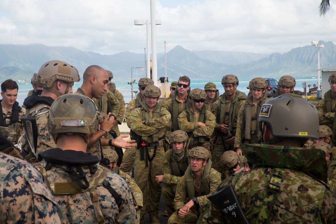 Australian soldiers and U.S. Marines with the 3rd Reconnaissance Battalion discuss helo-cast procedures during Rim of the Pacific (RIMPAC) exercise on Marine Corps Base Hawaii June 29, 2018. The helo-cast training is meant to prepare the service members for an amphibious insertion during RIMPAC. RIMPAC provides high-value training for task-organized, highly-capable Marine Air-Ground Task Force and enhances the critical crisis response capability of U.S. Marines in the Pacific. Twenty-five nations, 46 ships, five submarines, about 200 aircraft and 25,000 personnel are participating in RIMPAC from June 27 to Aug. 2 in and around the Hawaiian Islands and Southern California.