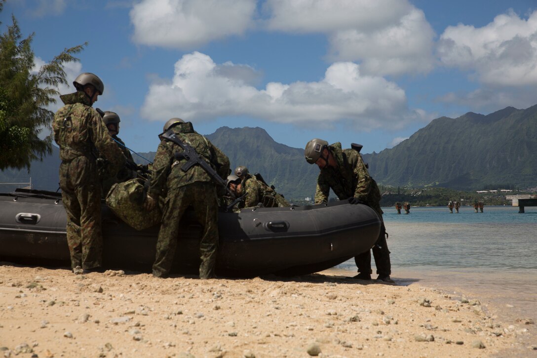 Australian soldiers inspect their combat rubber raiding craft during helo-cast drills as part of Rim of the Pacific (RIMPAC) exercise on Marine Corps Base Hawaii June 29, 2018. The helo-cast training is meant to prepare the service members for an amphibious insertion during RIMPAC. RIMPAC provides high-value training for task-organized, highly-capable Marine Air-Ground Task Force and enhances the critical crisis response capability of U.S. Marines in the Pacific. Twenty-five nations, 46 ships, five submarines, about 200 aircraft and 25,000 personnel are participating in RIMPAC from June 27 to Aug. 2 in and around the Hawaiian Islands and Southern California.