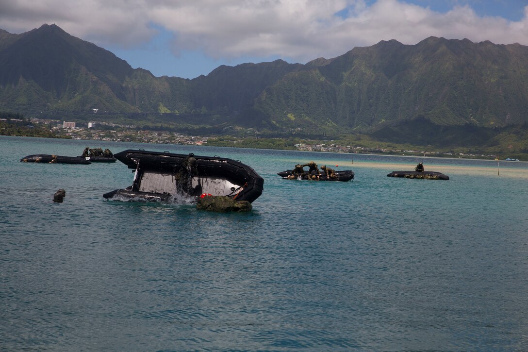 Australian soldiers  and U.S. Marines with the 3rd Reconnaissance Battalion rehearse helo-cast drills with a combat rubber raiding craft during Rim of the Pacific (RIMPAC) on Marine Corps Base Hawaii, June 29, 2018. The helo-cast training is meant to prepare the service members for an amphibious insertion during RIMPAC. RIMPAC provides high-value training for task-organized, highly-capable Marine Air-Ground Task Force and enhances the critical crisis response capability of U.S. Marines in the Pacific. Twenty-five nations, 46 ships, five submarines, about 200 aircraft and 25,000 personnel are participating in RIMPAC from June 27 to Aug. 2 in and around the Hawaiian Islands and Southern California. (U.S. Marine Corps photo by Lance Cpl. Thomas P. Miller)