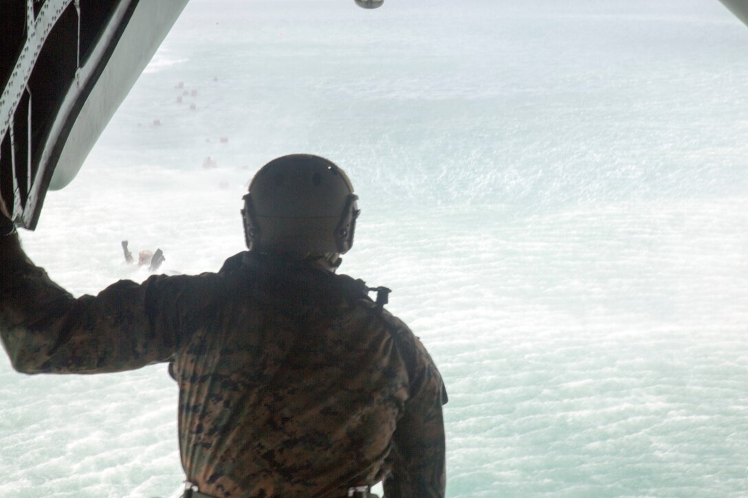 A U.S. Marine with 3rd Reconnaissance Battalion prepares to jump from a CH-53E Super Stallion helicopter during helo-cast training as part of Rim of the Pacific (RIMPAC) exercise off the coast of Marine Corps Base Hawaii June 30, 2018. The helo-cast training is meant to prepare the service members for an amphibious insertion during RIMPAC. RIMPAC provides high-value training for task-organized, highly-capable Marine Air-Ground Task Force and enhances the critical crisis response capability of U.S. Marines in the Pacific. Twenty-five nations, 46 ships, five submarines, about 200 aircraft and 25,000 personnel are participating in RIMPAC from June 27 to Aug. 2 in and around the Hawaiian Islands and Southern California.