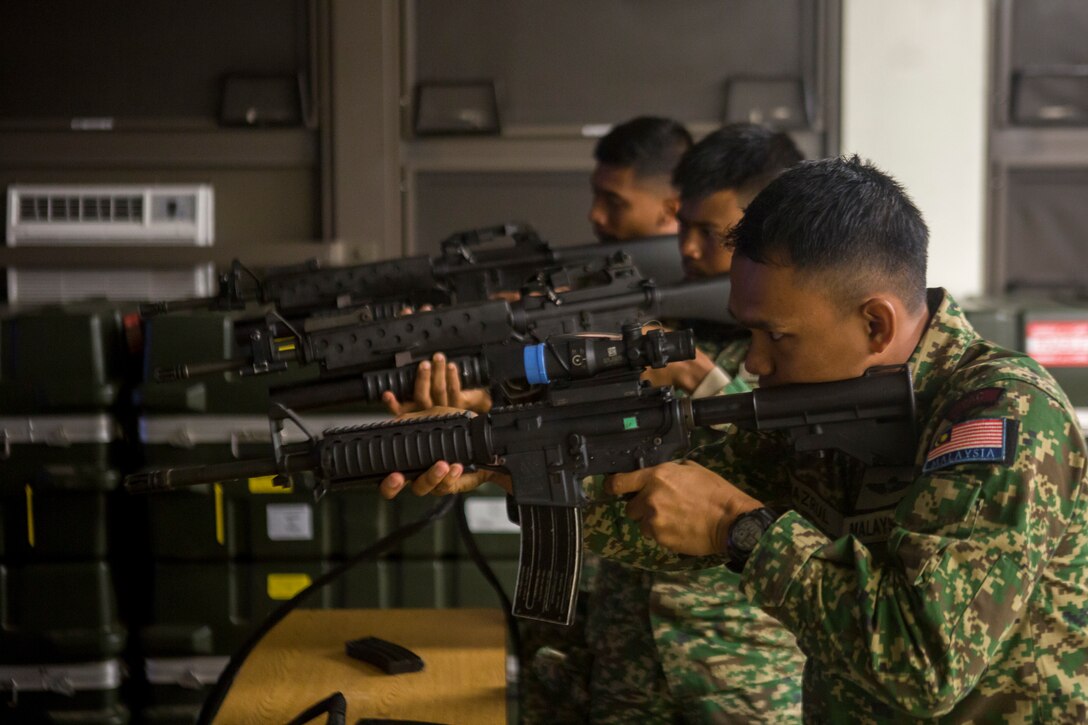 Indonesian Marines fire a stimulated M4 carbine in an indoor simulated marksmanship trainer during Rim of the Pacific (RIMPAC) exercise on Marine Corps Base Hawaii June 30, 2018. RIMPAC provides high-value training for task-organized, highly-capable Marine Air-Ground Task Force and enhances the critical crisis response capability of U.S. Marines in the Pacific. Twenty-five nations, 46 ships, five submarines, about 200 aircraft and 25,000 personnel are participating in RIMPAC from June 27 to Aug. 2 in and around the Hawaiian Islands and Southern California.