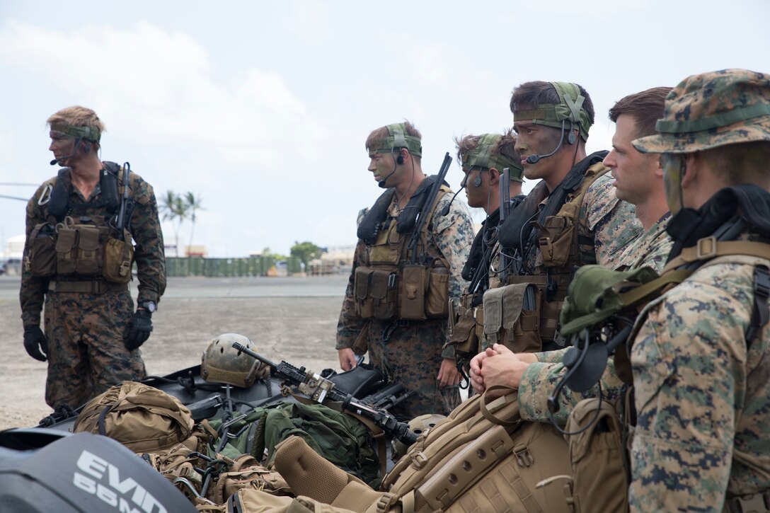 U.S. Marines with the 3rd Reconnaissance Battalion listen to a brief during amphibious operations as part of Rim of the Pacific (RIMPAC) exercise on Marine Corps Base Hawaii July 2, 2018. RIMPAC provides high-value training for task-organized, highly-capable Marine Air-Ground Task Force and enhances the critical crisis response capability of U.S. Marines in the Pacific. Twenty-five nations, 46 ships, five submarines, about 200 aircraft and 25,000 personnel are participating in RIMPAC from June 27 to Aug. 2 in and around the Hawaiian Islands and Southern California.