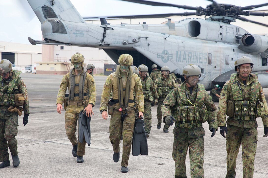 Australian soldiers with 2nd Battalion, Royal Australian Regiment, and Japanese soldiers with 2nd Regiment, Amphibious Rapid Deployment Brigade, disembark a CH-53E Super Stallion helicopter during amphibious operations as part of Rim of the Pacific (RIMPAC) exercise on Marine Corps Base Hawaii July 2, 2018. Twenty-Five nations, more than 45 ships and submarines, about 200 aircraft, and 25,000 personnel are participating in RIMPAC from June 27 to Aug. 2 in and around the Hawaiian Islands and Southern California. The world's largest international maritime exercise, RIMPAC provides a unique training opportunity while fostering and sustaining cooperative relationships among participants critical to ensuring the safety of sea lanes and security of the world's oceans.