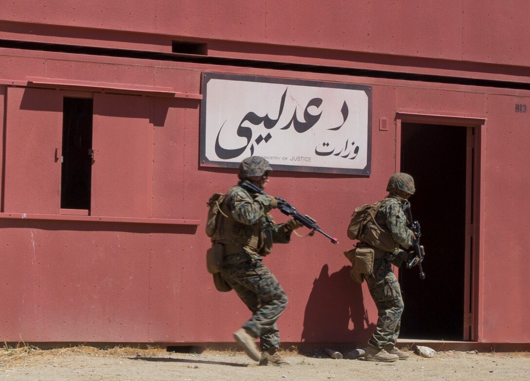 U.S. Marines with 2nd Battalion, 1st Marine Regiment, breach a building during a combat-town drill as part of Rim of the Pacific (RIMPAC) exercise at Marine Corps Base Camp Pendleton, California, July 2, 2018. RIMPAC demonstrates the value of amphibious forces and provides high-value training for task-organized, highly-capable Marine Air-Ground Task Forces enhancing the critical crisis response capability of U.S. Marines in the Pacific. Twenty-five nations, 46 ships, five submarines, about 200 aircraft and 25,000 personnel are participating in RIMPAC from June 27 to Aug. 2 in and around the Hawaiian Islands and Southern California.