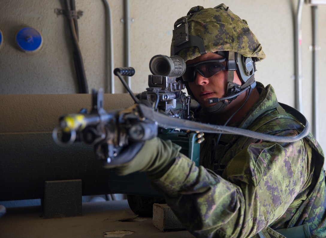 Canadian Army Sdt. Tondreau Blanchet, a machine gunner with Royal 22e Régiment, provides security during a combat-town drill as part of Rim of the Pacific (RIMPAC) exercise at Marine Corps Base Camp Pendleton, California, July 2, 2018. RIMPAC demonstrates the value of amphibious forces and provides high-value training for task-organized, highly-capable Marine Air-Grounrid Task Forces enhancing the critical crisis response capability of U.S. Marines in the Pacific. Twenty-five nations, 46 ships, five submarines, about 200 aircraft and 25,000 personnel are participating in RIMPAC from June 27 to Aug. 2 in and around the Hawaiian Islands and Southern California.