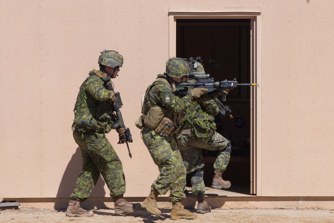 Canadian soldiers with Royal 22e Régiment breach a building during a combat-town drill as part of Rim of the Pacific (RIMPAC) exercise at Marine Corps Base Camp Pendleton, California, July 2, 2018. RIMPAC demonstrates the value of amphibious forces and provides high-value training for task-organized, highly-capable Marine Air-Ground Task Forces enhancing the critical crisis response capability of U.S. Marines in the Pacific. Twenty-five nations, 46 ships, five submarines, about 200 aircraft and 25,000 personnel are participating in RIMPAC from June 27 to Aug. 2 in and around the Hawaiian Islands and Southern California.