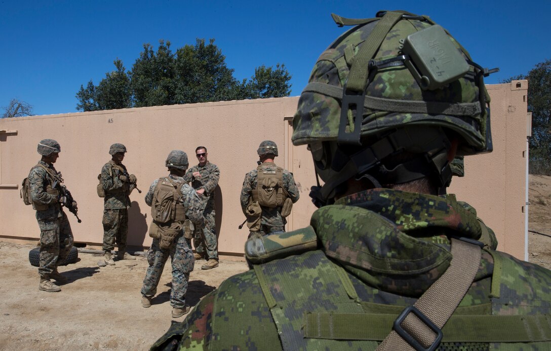 Canadian Army Sdt. Michael Simard, a rifleman with Royal 22e Régiment, observes the U.S. Marines with 2nd Battalion, 1st Marine Regiment, during a combat-town drill as part of Rim of the Pacific (RIMPAC) exercise at Marine Corps Base Camp Pendleton, California, July 2, 2018. RIMPAC demonstrates the value of amphibious forces and provides high-value training for task-organized, highly-capable Marine Air-Ground Task Forces enhancing the critical crisis response capability of U.S. Marines in the Pacific. Twenty-five nations, 46 ships, five submarines, about 200 aircraft and 25,000 personnel are participating in RIMPAC from June 27 to Aug. 2 in and around the Hawaiian Islands and Southern California.