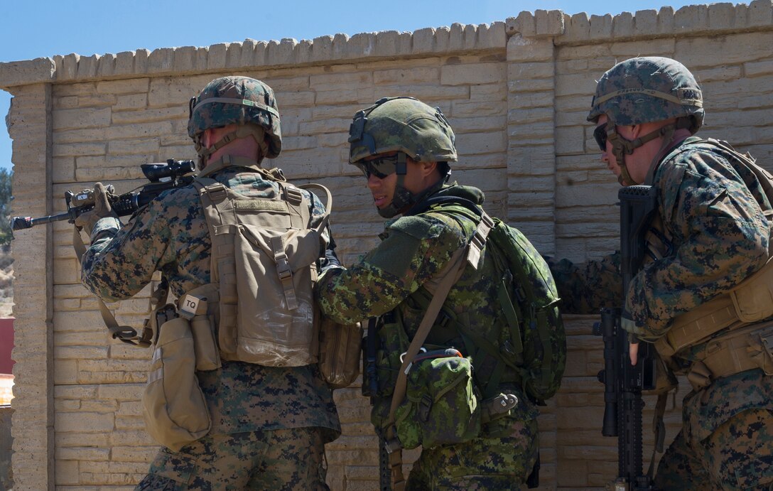 Canadian soldiers with Royal 22e Régiment, and U.S. Marines with 2nd Battalion, 1st Marine Regiment, prepare to enter a combat town as part of Rim of the Pacific (RIMPAC) exercise at Marine Corps Base Camp Pendleton, California, July 2, 2018. RIMPAC demonstrates the value of amphibious forces and provides high-value training for task-organized, highly-capable Marine Air-Ground Task Forces enhancing the critical crisis response capability of U.S. Marines in the Pacific. Twenty-five nations, 46 ships, five submarines, about 200 aircraft and 25,000 personnel are participating in RIMPAC from June 27 to Aug. 2 in and around the Hawaiian Islands and Southern California.