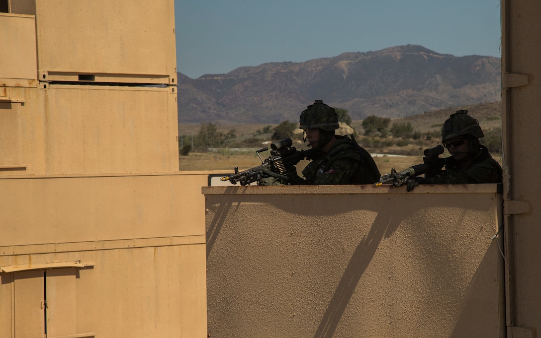 Canadian soldiers with the Royal 22e Régiment provide security during a simulated raid at a combat town as part of Rim of the Pacific (RIMPAC) exercise at Marine Corps Base Camp Pendleton, California, July 3, 2018. RIMPAC demonstrates the value of amphibious forces and provides high-value training for task-organized, highly-capable Marine Air-Ground Task Forces enhancing the critical crisis response capability of U.S. Marines in the Pacific. Twenty-five nations, 46 ships, five submarines, about 200 aircraft and 25,000 personnel are participating in RIMPAC from June 27 to Aug. 2 in and around the Hawaiian Islands and Southern California.