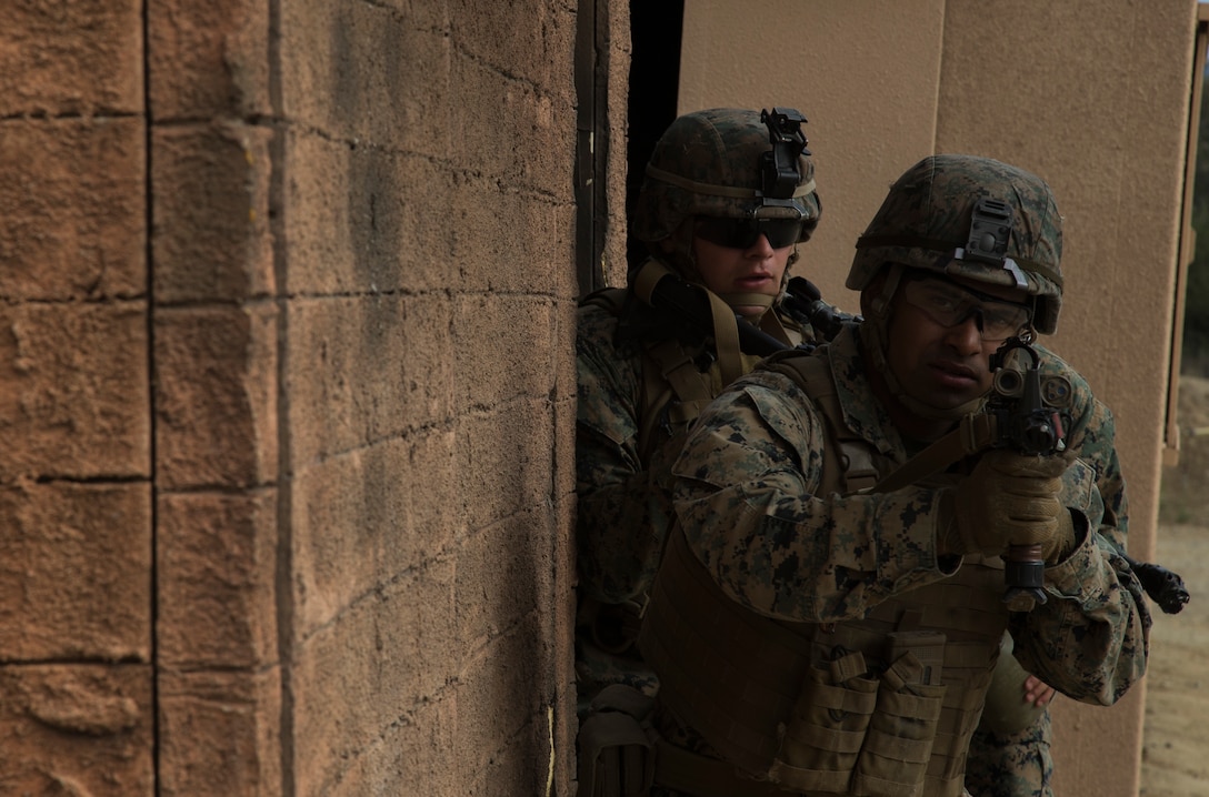 U.S. Marine Corps Lance Cpl. Jonathan Ibarra, an infantryman with Company F, 2nd Battalion, 1st Marine Regiment, looks for simulated enemy combatants during a simulated raid as part of Rim of the Pacific (RIMPAC) exercise at Marine Corps Base Camp Pendleton, California, July 3, 2018. RIMPAC demonstrates the value of amphibious forces and provides high-value training for task-organized, highly-capable Marine Air-Ground Task Forces enhancing the critical crisis response capability of U.S. Marines in the Pacific. Twenty-five nations, 46 ships, five submarines, about 200 aircraft and 25,000 personnel are participating in RIMPAC from June 27 to Aug. 2 in and around the Hawaiian Islands and Southern California.