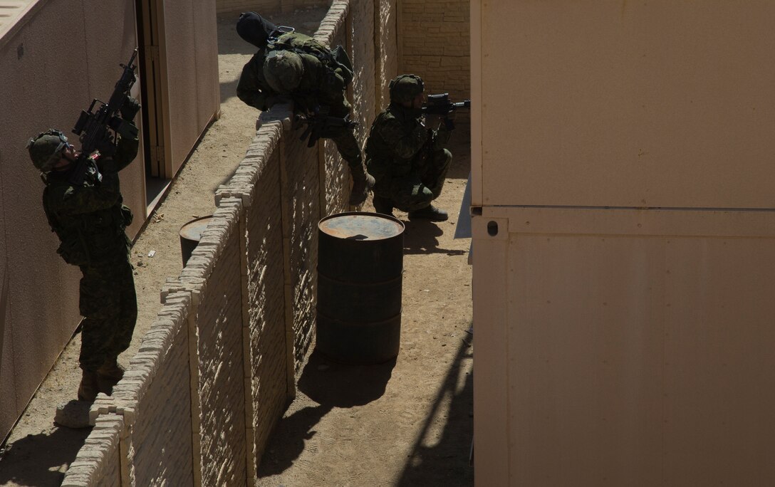 Canadian soldiers with the Royal 22e Régiment and U.S. Marines with Company F, 2nd Battalion, 1st Marine Regiment, conduct squad-level training at a combat town as part of Rim of the Pacific (RIMPAC) exercise at Marine Corps Base Camp Pendleton, California, July 3, 2018. RIMPAC demonstrates the value of amphibious forces and provides high-value training for task-organized, highly-capable Marine Air-Ground Task Forces enhancing the critical crisis response capability of U.S. Marines in the Pacific. Twenty-five nations, 46 ships, five submarines, about 200 aircraft and 25,000 personnel are participating in RIMPAC from June 27 to Aug. 2 in and around the Hawaiian Islands and Southern California.