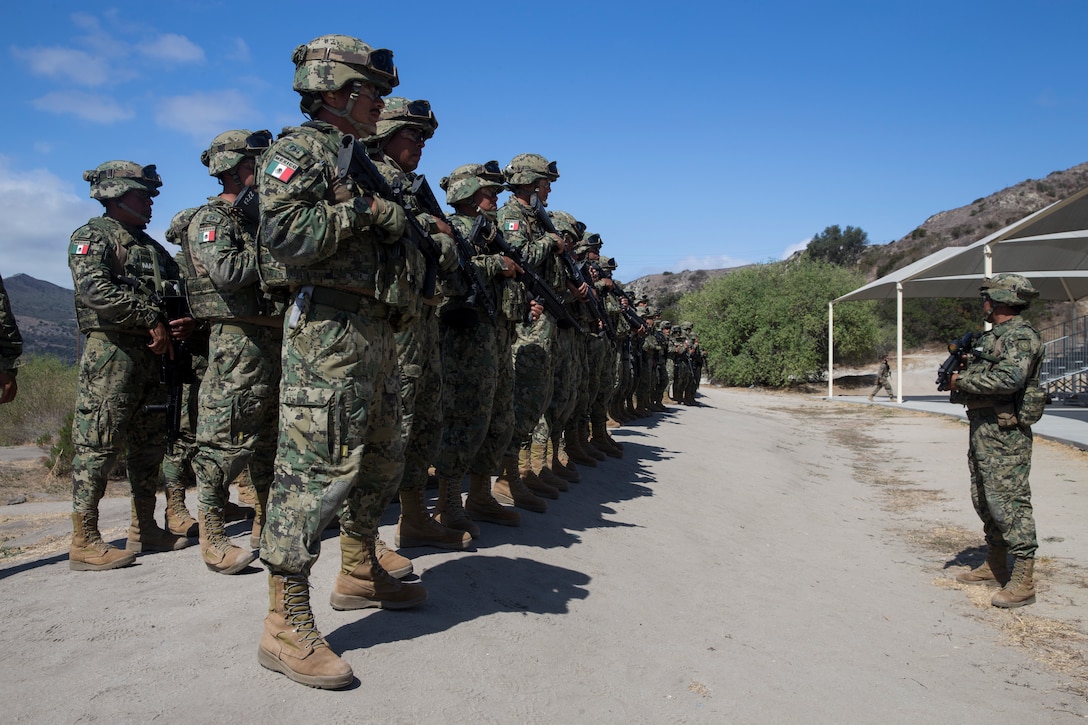 Mexican marines with Amphibious Marine Infantry Brigade form for accountability of weapons and personnel during Rim of the Pacific (RIMPAC) exercise at Marine Corps Base Camp Pendleton, California, July 3, 2018. RIMPAC demonstrates the value of amphibious forces and provides high-value training for task-organized, highly-capable Marine Air-Ground Task Forces enhancing the critical crisis response capability of U.S. forces and partners globally. Twenty-five nations, 46 ships, five submarines, about 200 aircraft and 25,000 personnel are participating in RIMPAC from June 27 to Aug. 2 in and around the Hawaiian Islands and Southern California.